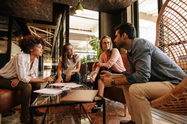 young people chatting in open office space