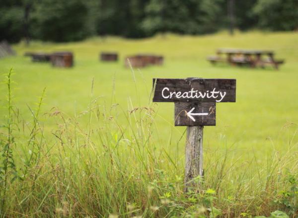 wooden creativity sign in grass
