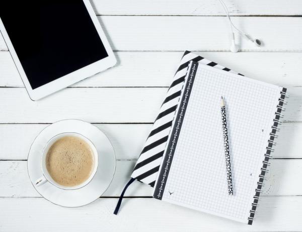 notebook coffee and tablet on desk