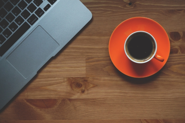 Landmark office space coffee. A red cup of coffee and a laptop